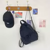 Nylon School Backpack with Bow Front and Drawstring Side Pocket Black color SKU reference