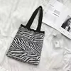 Woven Plaid Shoulder Tote with Mixed Pattern Options Zebra pattern handle style reference