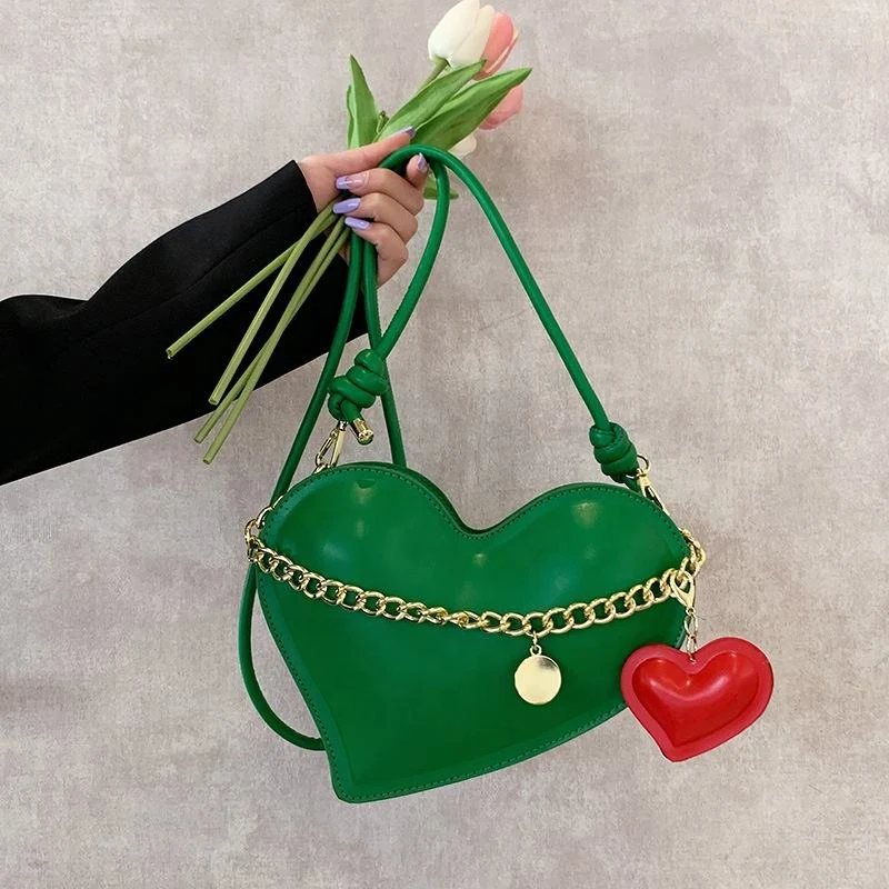 Heart-Shaped PU Crossbody Bag with Pendant Detail product reference image