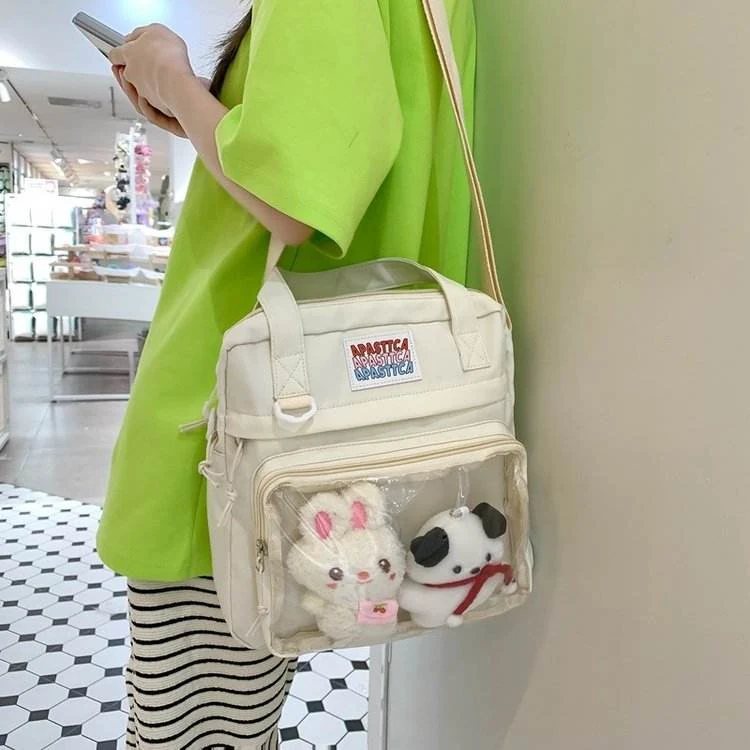 Nylon Crossbody Bag with Transparent Window and Doll Charms product reference image