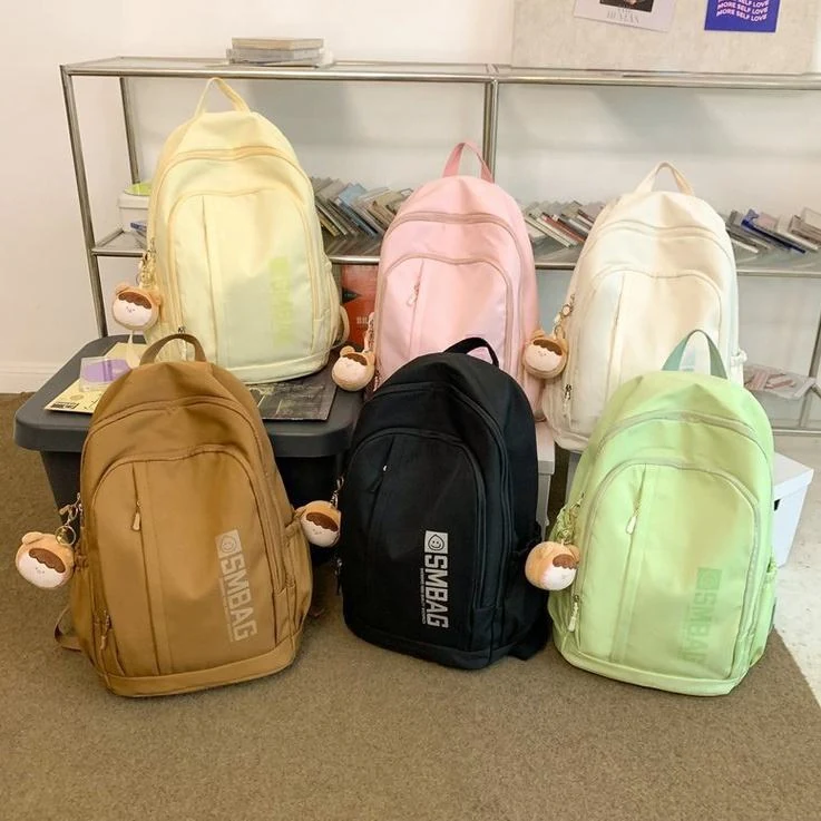 Nylon Student and Travel Backpack with Decorative Doll Charm product reference image