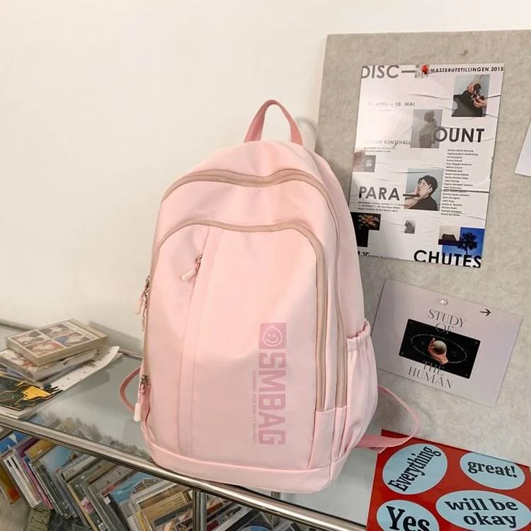 Nylon Student and Travel Backpack with Decorative Doll Charm Red color SKU reference