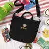 Cotton Messenger Tote with Embroidered Character Details Black color SKU reference